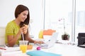 Woman Working In Design Studio Having Lunch At Desk Royalty Free Stock Photo