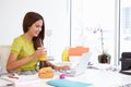 Woman Working In Design Studio Having Lunch At Desk Royalty Free Stock Photo