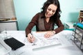 Woman on working desk with blueprints in front Royalty Free Stock Photo