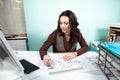 Woman on working desk with blueprints in front Royalty Free Stock Photo