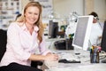 Woman Working At Desk In Busy Creative Office Royalty Free Stock Photo