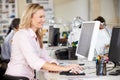 Woman Working At Desk In Busy Creative Office Royalty Free Stock Photo