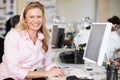 Woman Working At Desk In Busy Creative Office Royalty Free Stock Photo