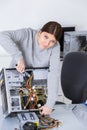 Woman working on dismantled computer Royalty Free Stock Photo