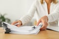 Woman working with documents at wooden table in office, closeup Royalty Free Stock Photo