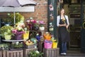 Woman working at flower shop smiling Royalty Free Stock Photo