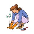 Woman working in the garden, planting a seedling