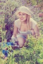 Woman working in garden using horticultural instruments on summer day Royalty Free Stock Photo