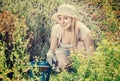 Woman working in garden using horticultural instruments on summer day Royalty Free Stock Photo