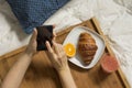 Woman working with her mobile and having breakfast