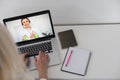 Woman Working From Home Having Group Videoconference On Laptop