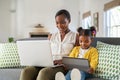 Woman working from home while her daughter using digital tablet Royalty Free Stock Photo