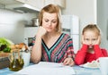 Woman working from home, little daughter asking for attention Royalty Free Stock Photo