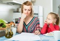 Woman working from home, little daughter asking for attention Royalty Free Stock Photo