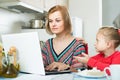 Woman working from home, little daughter asking for attention Royalty Free Stock Photo