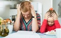 woman working from home, little daughter asking for attention Royalty Free Stock Photo