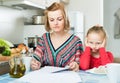 Woman working from home, little daughter asking for attention Royalty Free Stock Photo