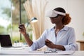Woman Working From Home Office With Controllers Wearing VR Headset Interacting With AR Technology Royalty Free Stock Photo