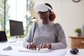 Woman Working From Home Office Sitting At Desk Wearing VR Headset Using AR Technology Royalty Free Stock Photo