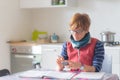 Woman working at home, reading and handwriting documents