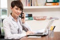 Woman Working From Home Using Laptop On Phone Royalty Free Stock Photo