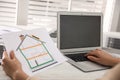 Woman working on house project with solar panels at table in office Royalty Free Stock Photo