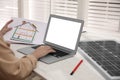 Woman working on house project with solar panels at table in office Royalty Free Stock Photo