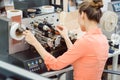 Woman working on label printing machine Royalty Free Stock Photo