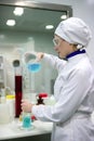 Woman working laboratory, glass cylinder vase Royalty Free Stock Photo