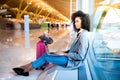 Woman working with laptop at the airport waiting at the window Royalty Free Stock Photo