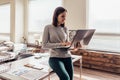 Woman working on laptop computer sitting on table