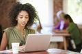 Woman Working At Laptop In Contemporary Office