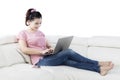 Woman working with laptop on cozy sofa Royalty Free Stock Photo