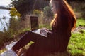 Woman is working with laptop in the forest. Stay connected concept.