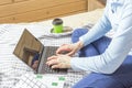 Woman working for laptop from home on bed. Girl using portable computer for writing on keyboard at her office with cup of coffee Royalty Free Stock Photo