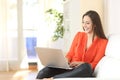 Woman working with a laptop at home