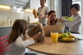 Woman working on laptop looking with terror on son homework Royalty Free Stock Photo