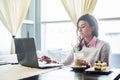 Woman working on laptop notebook computer at cafe, internet distance work, business lunch. Royalty Free Stock Photo