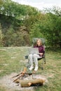 Woman working on laptop online on nature. Young freelancer relaxing in forest. Outdoor activity in summer. Travel, hiking, Royalty Free Stock Photo