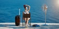 Woman working on laptop and relaxing on seashore. Lifestyle change idea. Business travelling, life work balance concept