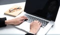 Woman working on laptop, sitting at the desk