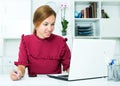 Woman working with laptop and taking notes Royalty Free Stock Photo