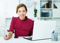 Woman working with laptop and taking notes Royalty Free Stock Photo