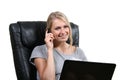 Woman working with laptop an talking on the phone Royalty Free Stock Photo