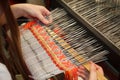 Woman working at the loom. Russian national crafts