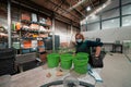 a woman working in a metal factory wears a mask on her face due to a coronavirus pandemic and prepares a piece of metal