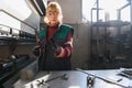 woman working in a modern factory and preparing materia for a CNC machine. Royalty Free Stock Photo