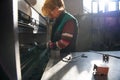 woman working in a modern factory and preparing materia for a CNC machine. Royalty Free Stock Photo