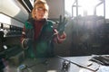 woman working in a modern factory and preparing materia for a CNC machine. Royalty Free Stock Photo