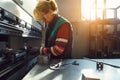 woman working in a modern factory and preparing materia for a CNC machine. Royalty Free Stock Photo